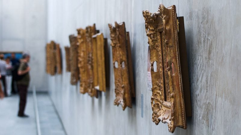 Ornate gold frames hanging on a gallery wall