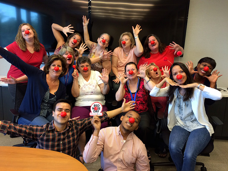Fun group shot of Argo Employees wearing red noses
