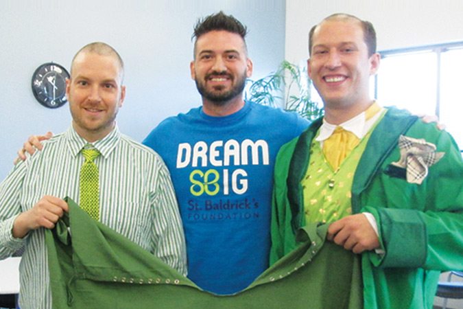 Men wearing green who shaved their heads to help raise funds for St. Baldrick's Foundation