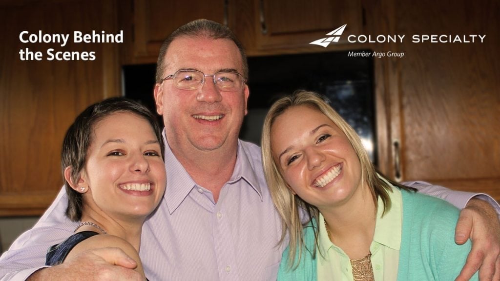 Colony Specialty employee Dan Folkes posing with two young women
