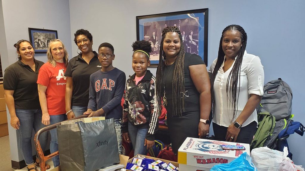 Argo Surety staff donating items to school children