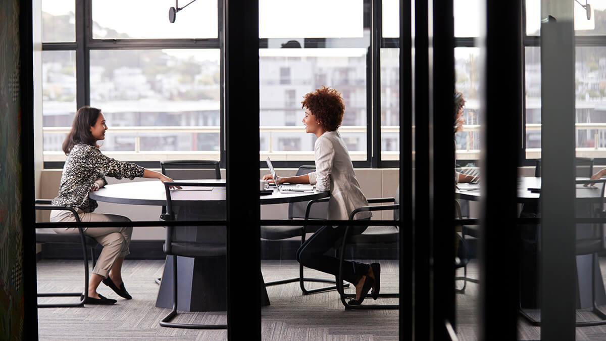 Millennial employees sitting at a conference table