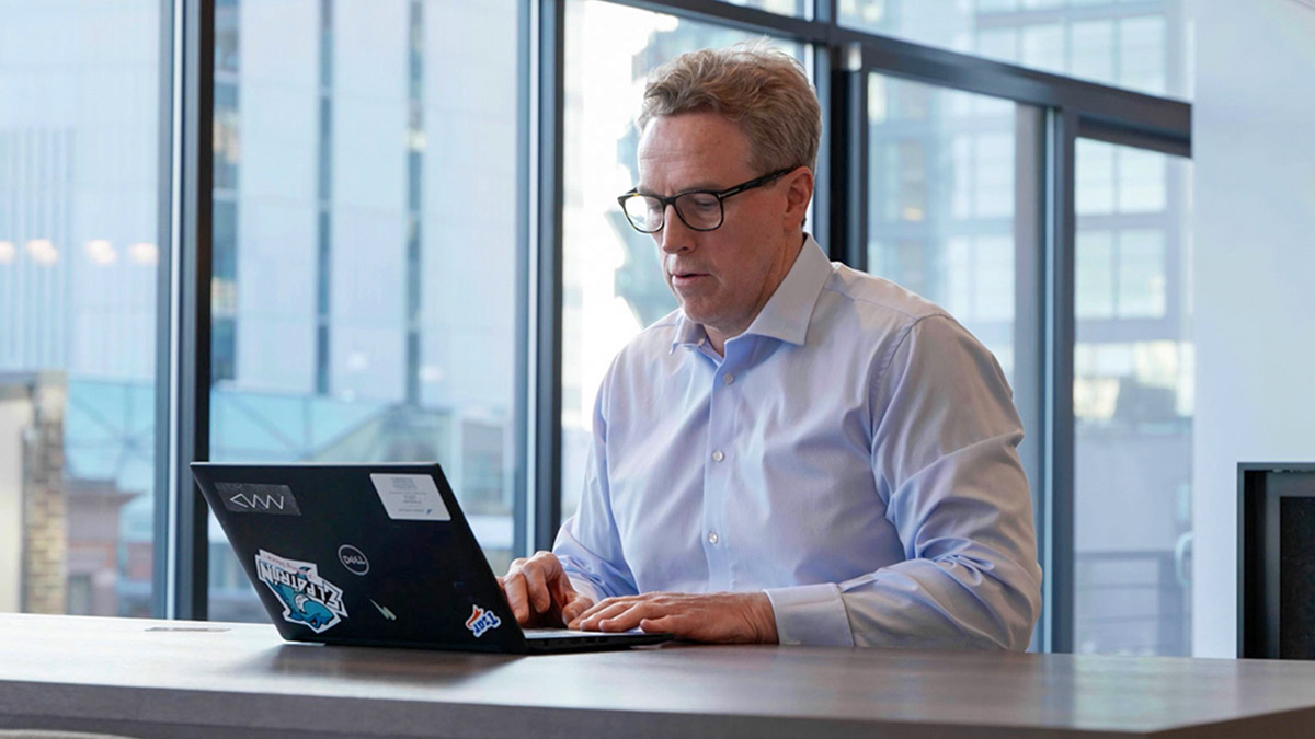 Ian Macartney works at a laptop flexible working in insurance